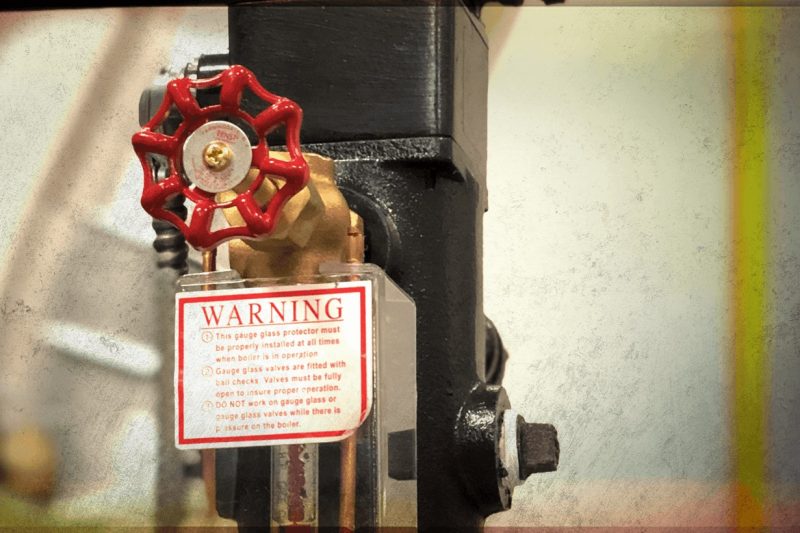 What exactly should be looked for when checking the gauges and controls in boilers?