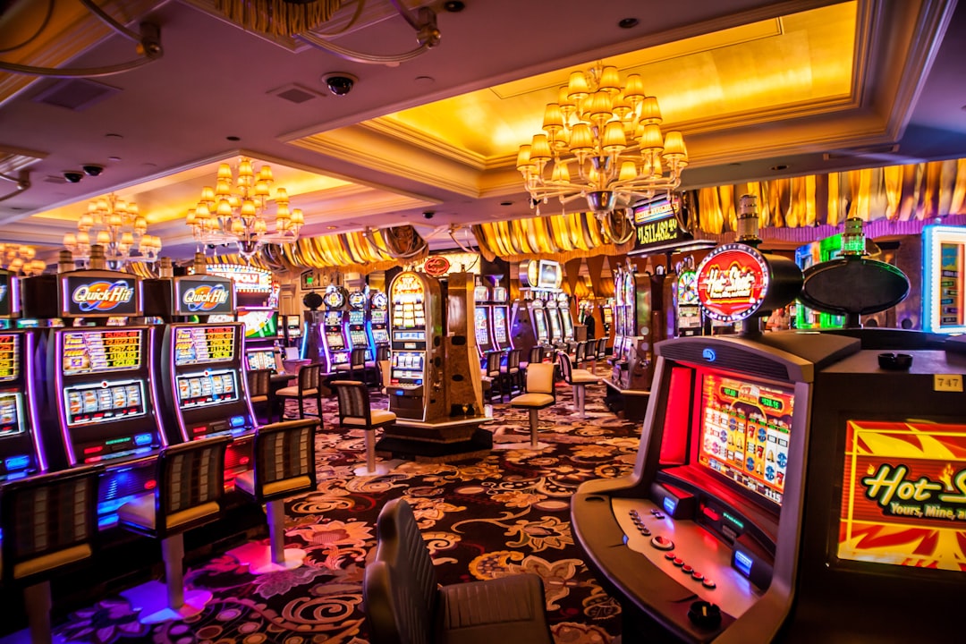 Interior view of a brightly lit casino floor with slot machines and elegant decor