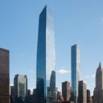 A skyline featuring modern skyscrapers against a clear blue sky